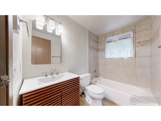 a bathroom with a sink a toilet a shower and a mirror