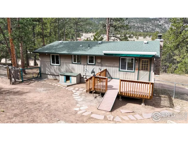 a view of a house with a balcony and wooden fence