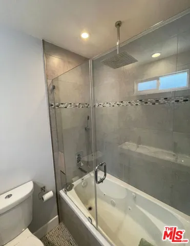 a bathroom with a tub and a shower