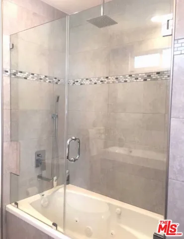 a bathroom with a bathtub and a shower