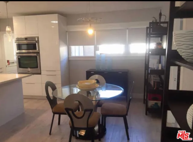 a dining room with furniture and wooden floor