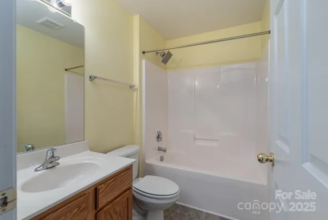 an empty room with a ceiling fan and a window