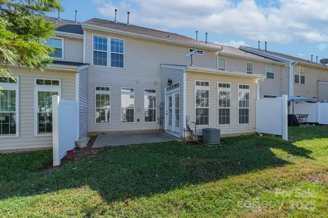 a view of a house with garden and a trees