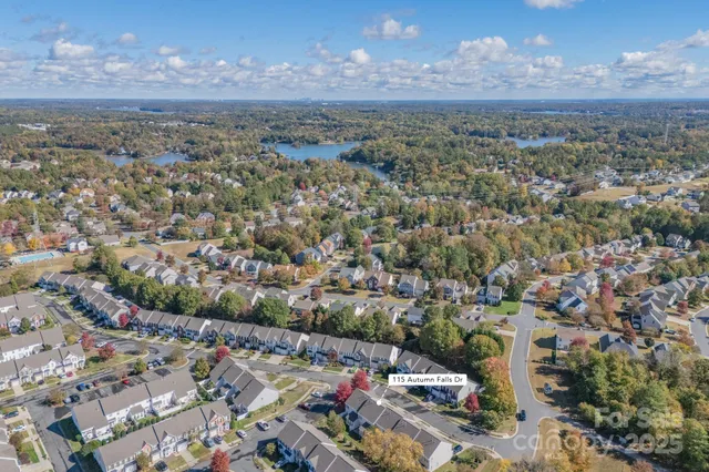 front view of a brick house with a yard