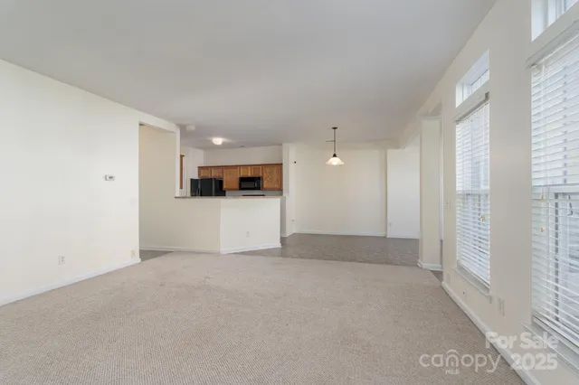 a view of a kitchen with a sink and a refrigerator