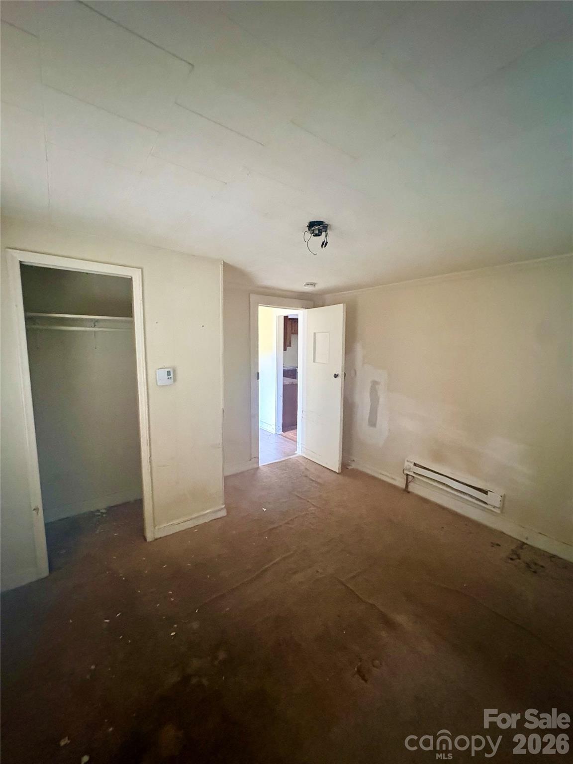 1105 John Miller Road Rockwell, NC 28138 - Photo 6 of 19 an empty room with an empty space and wooden floor
