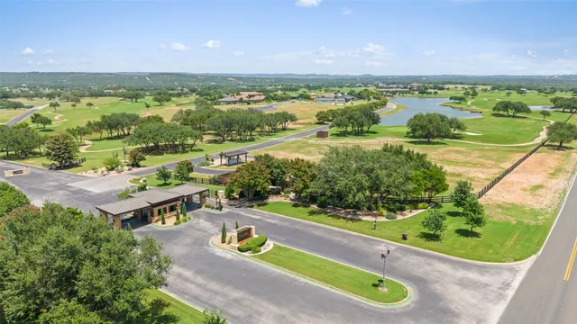 an aerial view of a house with swimming pool and a garden