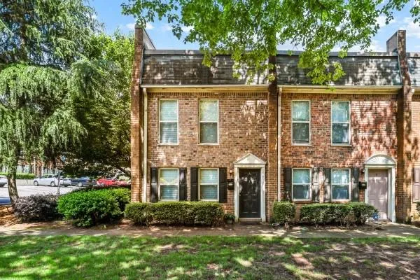 front view of a brick house with a yard