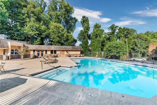 swimming pool view with a seating space