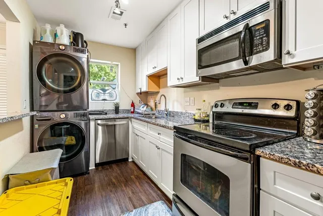 a kitchen with a stove a washer and dryer