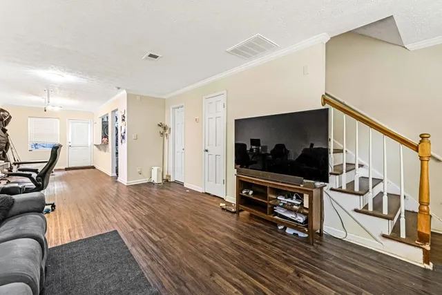 a living room with furniture and a flat screen tv