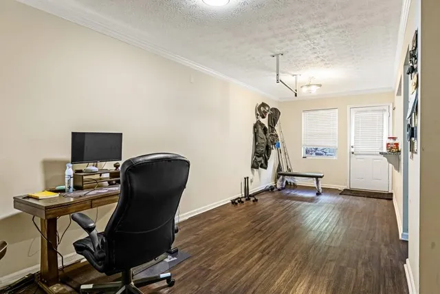 a view of a workspace with furniture and a window