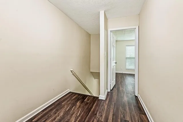 a view of a room with wooden floor