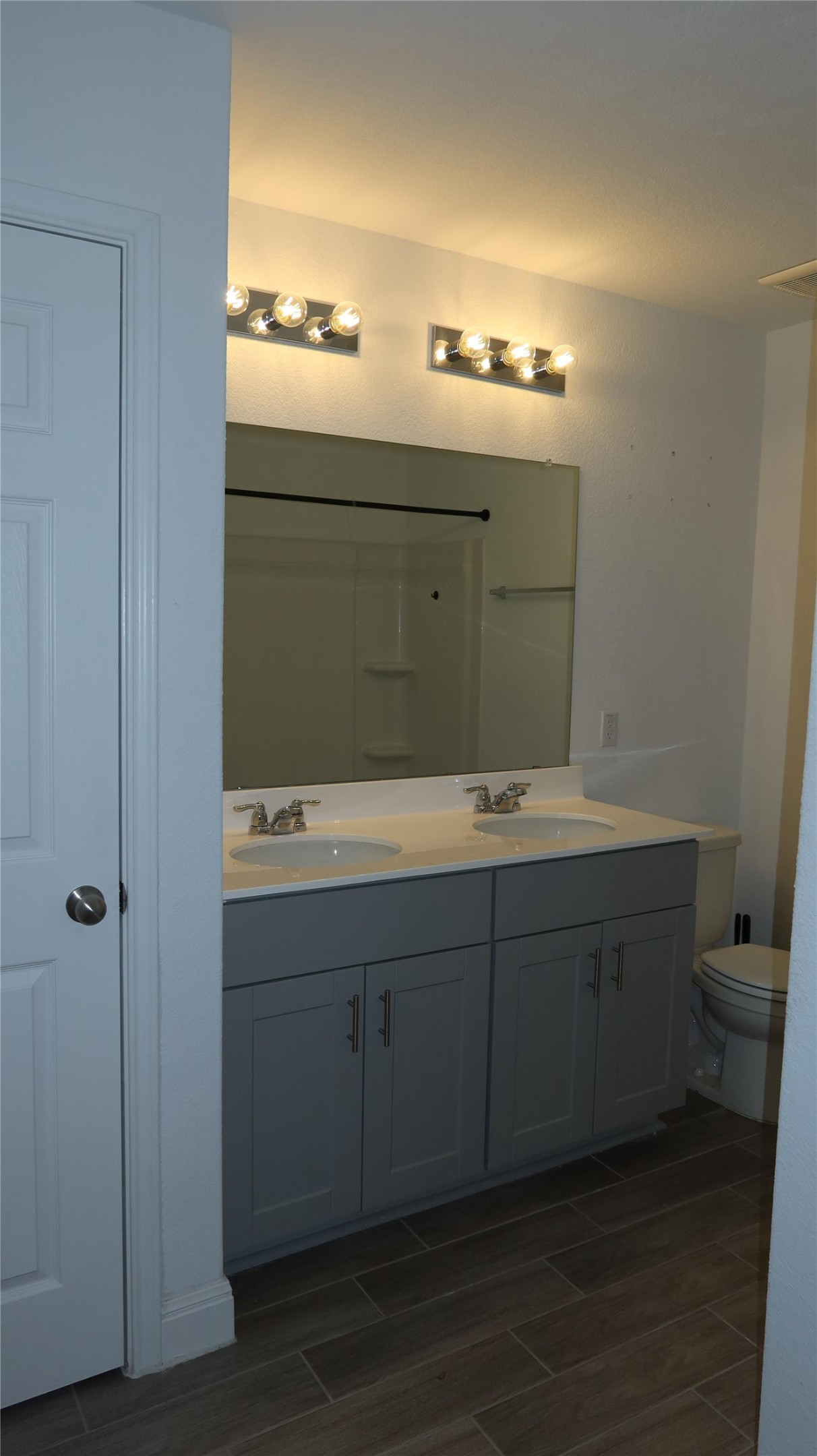 620 Acuff Lane Leander, TX 78641 - Photo 6 of 14 Bathroom featuring a dual vanity with grey shaker-style cabinetry, white countertops, and chrome fixtures