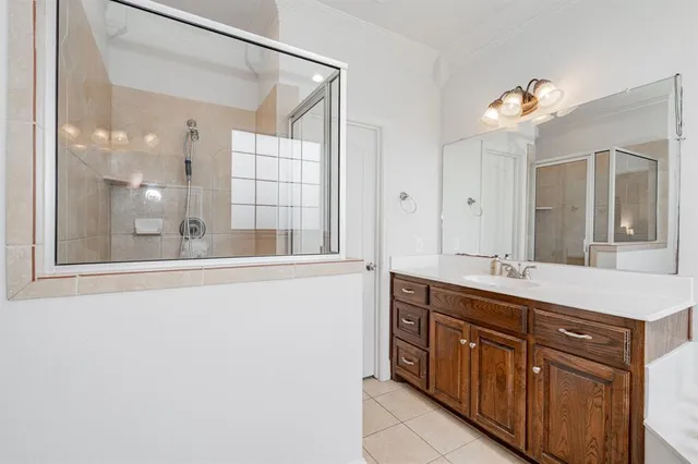 a bathroom with a sink mirror and a shower