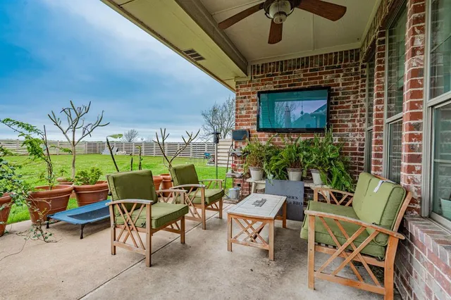 a backyard of a house with outdoor seating