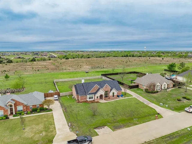 an aerial view of a house with outdoor space