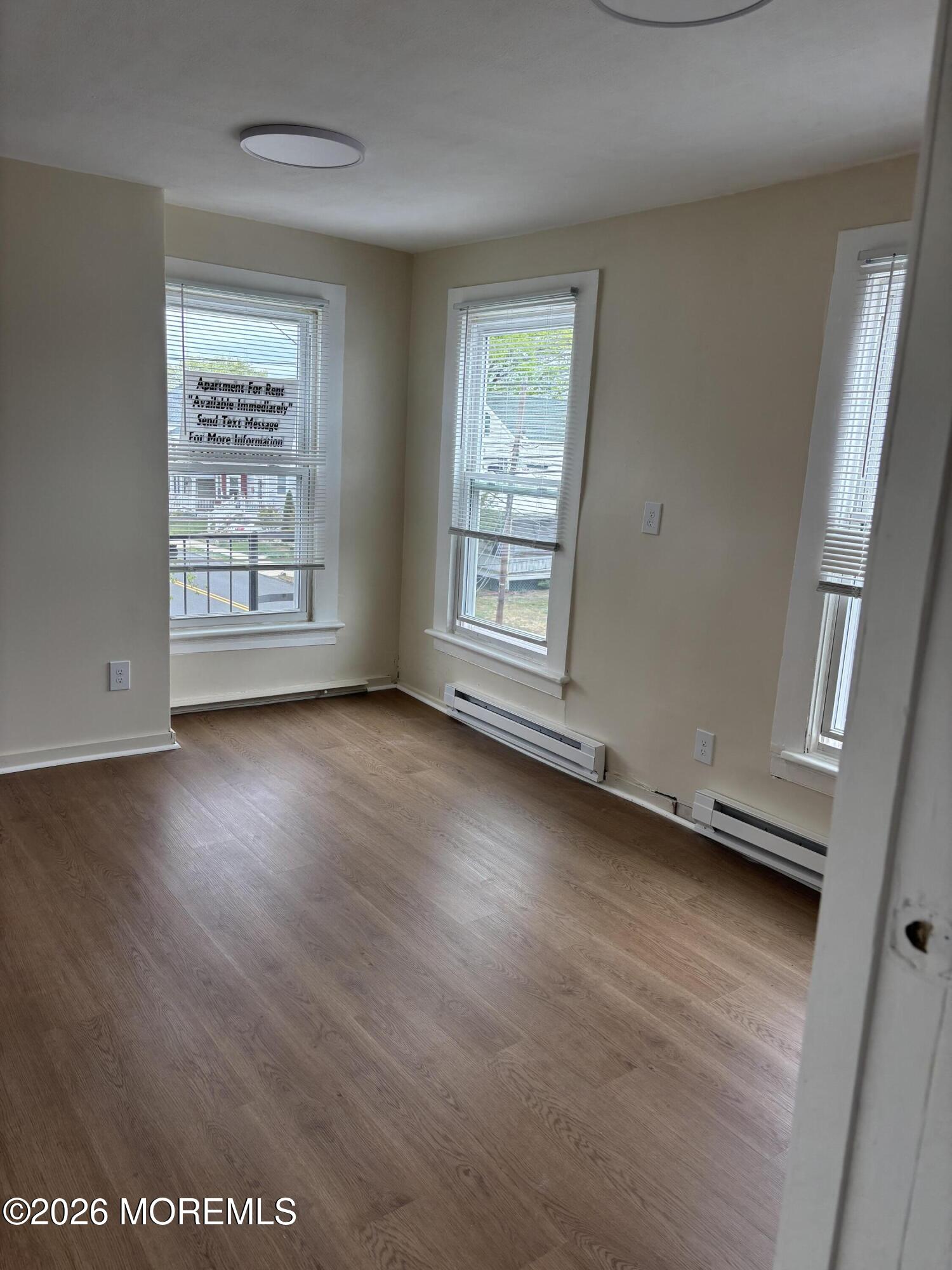 178 Broad Street, Unit D Keyport, NJ 07735 - Photo 1 of 7 an empty room with wooden floor and windows