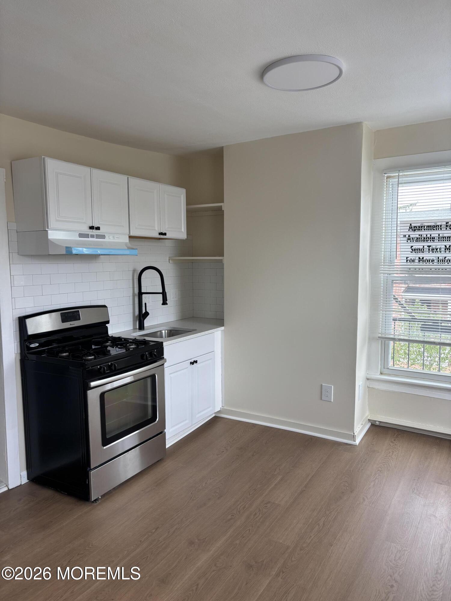 178 Broad Street, Unit D Keyport, NJ 07735 - Photo 2 of 7 a kitchen with stainless steel appliances a sink a stove and a window