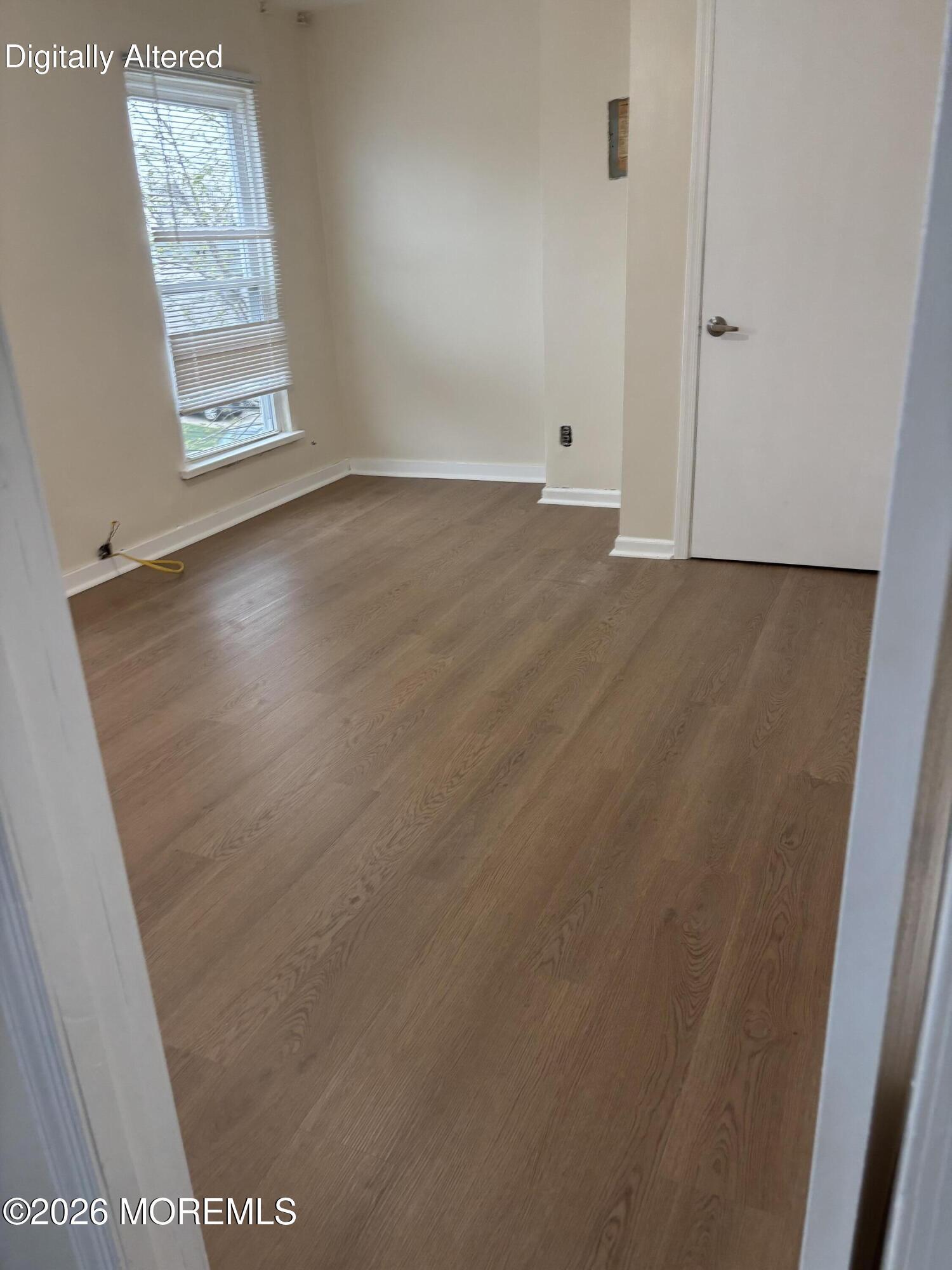 178 Broad Street, Unit D Keyport, NJ 07735 - Photo 7 of 7 an empty room with wooden floor and windows