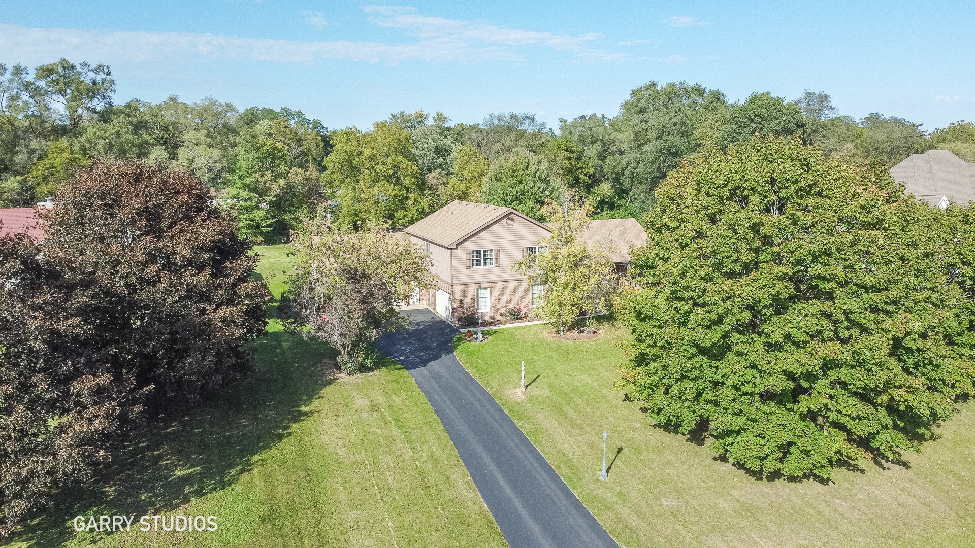 28824 Rivers Edge Drive Cary, IL 60013 - Photo 36 of 39 a view of a house with a yard and large trees
