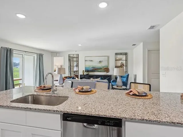 a kitchen with counter top space and living room