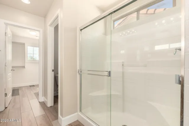 a bathroom with a glass shower door
