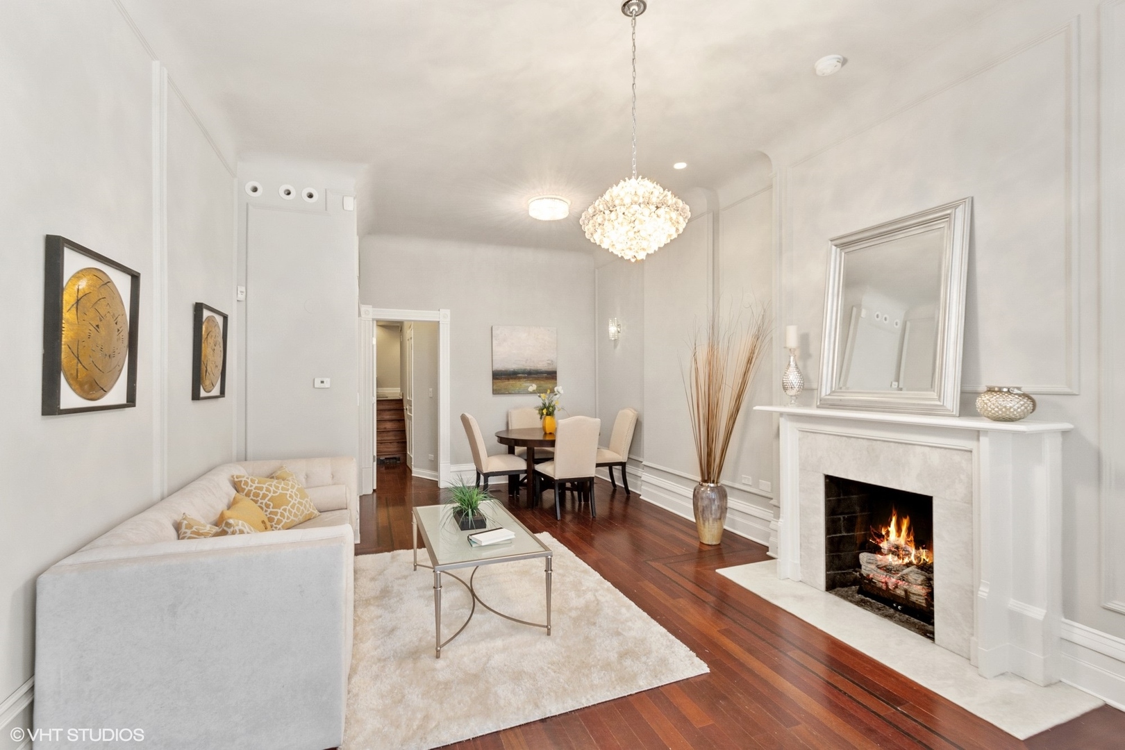 67 East Cedar Street Chicago, IL 60611 - Photo 7 of 37 a view of a livingroom with furniture a fireplace wooden floor and chandelier