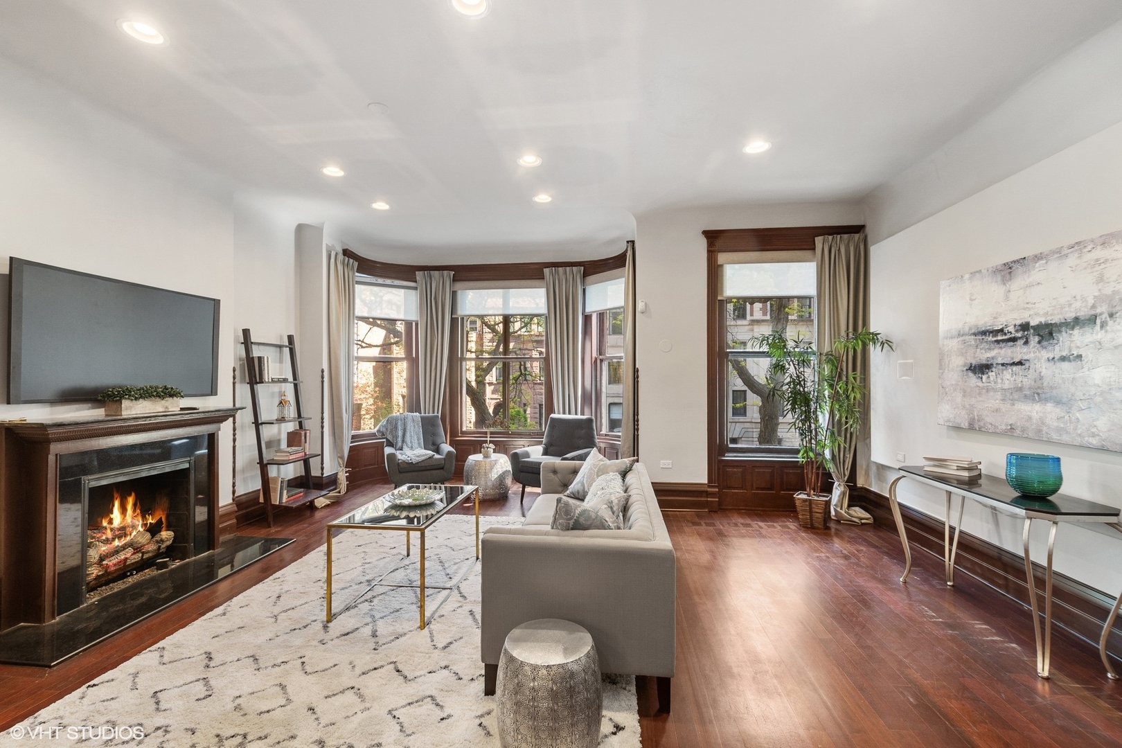 67 East Cedar Street Chicago, IL 60611 - Photo 10 of 37 a living room with furniture a flat screen tv and a fireplace