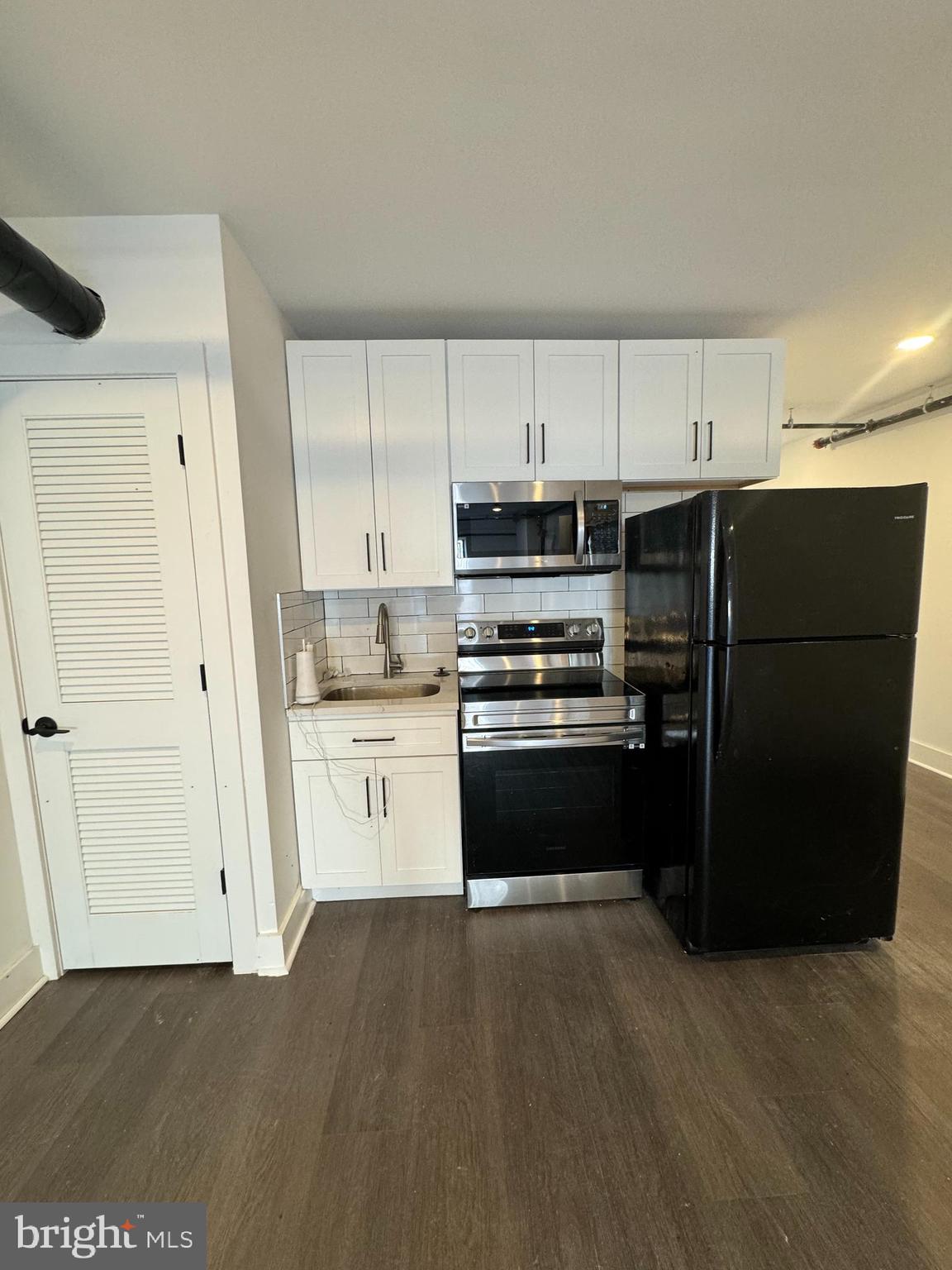 2331 East Thompson Street, Unit 1 Philadelphia, PA 19125 - Photo 4 of 6 a kitchen with a refrigerator and white cabinets