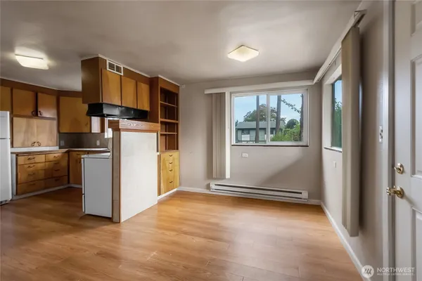 a view of kitchen with furniture refrigerator and microwave