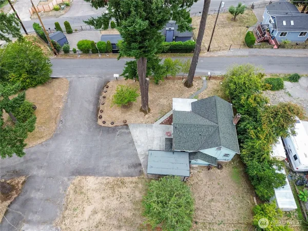 an aerial view of a house with a yard and garden