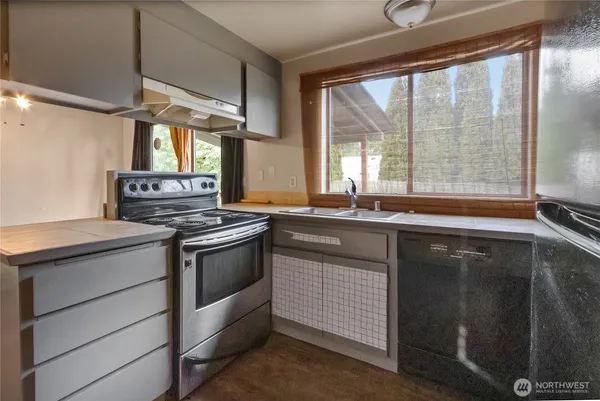 a kitchen with a sink stove and cabinets