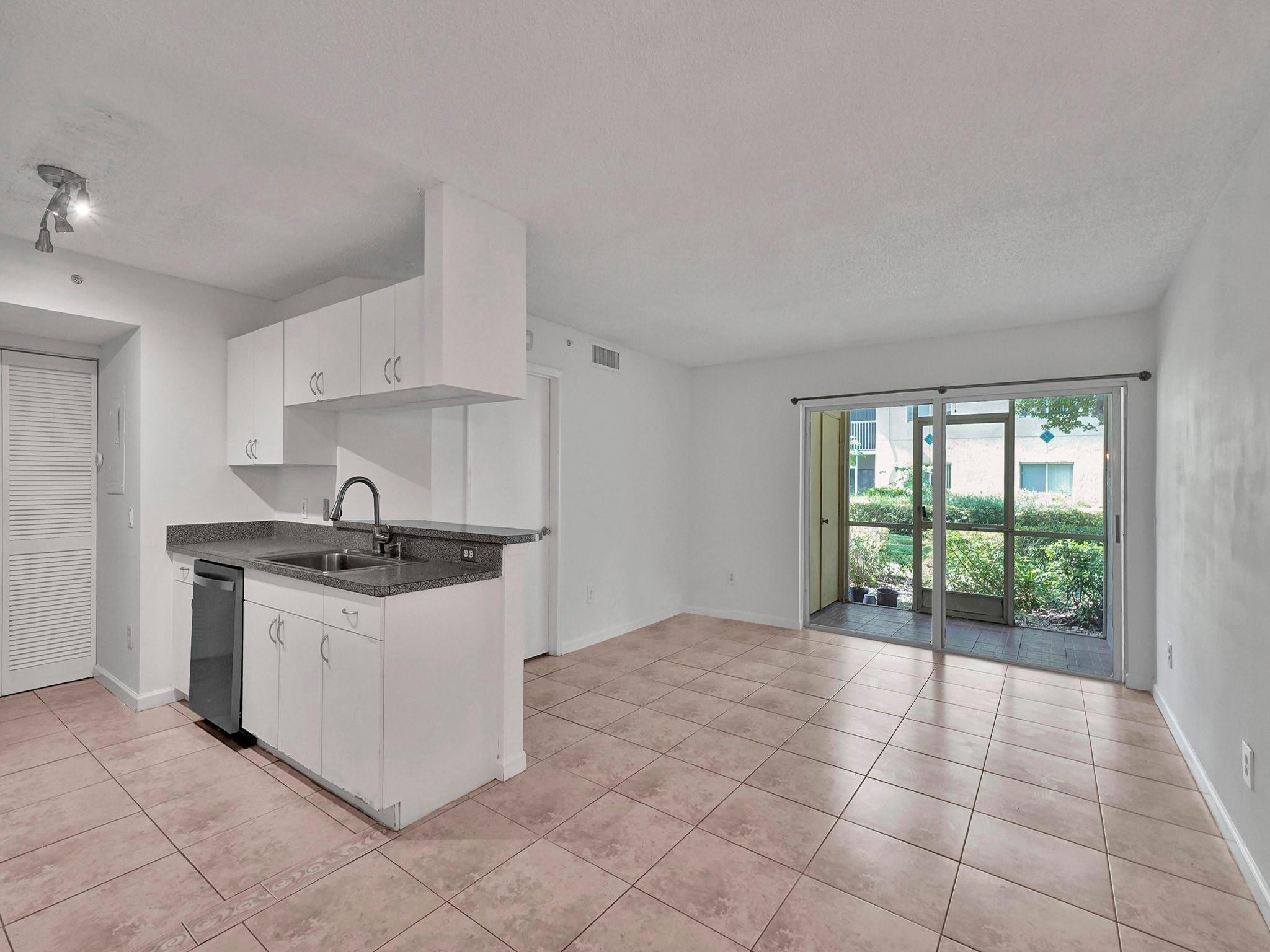 450 South Park Road, Unit 5103 Hollywood, FL 33021 - Photo 3 of 27 a kitchen with a stove top oven sink and cabinets