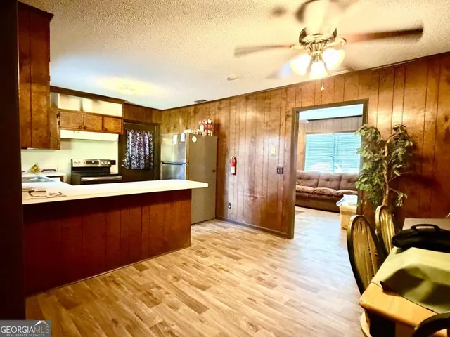 a bedroom with a bed and wooden floors