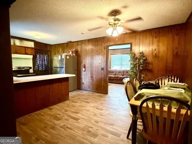a view of a dining room with furniture and chandelier