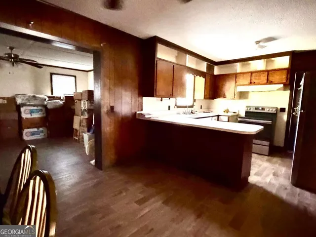 a kitchen with a sink and wooden cabinets