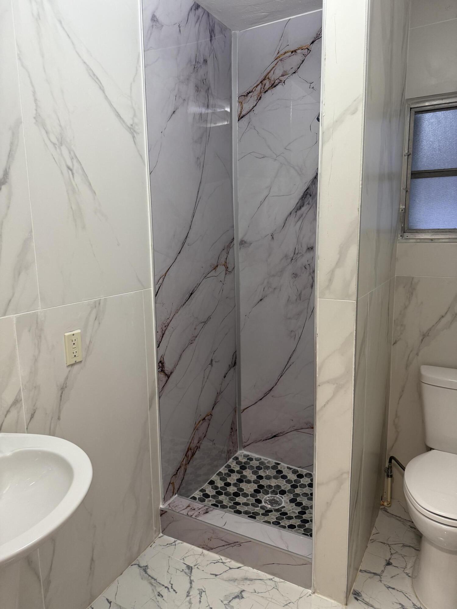 415 Southwest 8th Street Hallandale Beach, FL 33009 - Photo 3 of 10 a bathroom with a sink toilet and shower