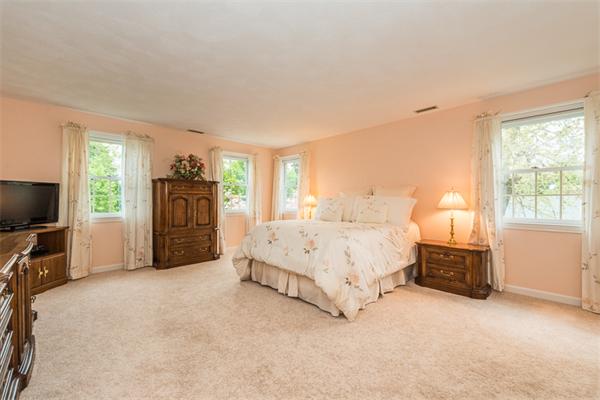 4 Farm Road Lexington, MA 02420 - Photo 15 of 28 a spacious bedroom with a bed and a television in it