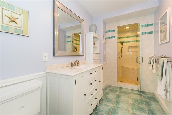 4 Farm Road Lexington, MA 02420 - Photo 18 of 28 a bathroom with a sink a mirror and a shower