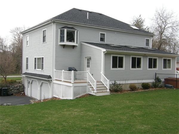 4 Farm Road Lexington, MA 02420 - Photo 22 of 28 a front view of a house with a garden