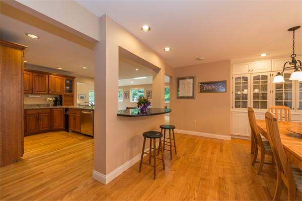 4 Farm Road Lexington, MA 02420 - Photo 8 of 28 a kitchen with stainless steel appliances wooden floor dining table and chairs