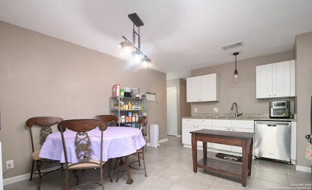 a view of a dining room with furniture and chandelier