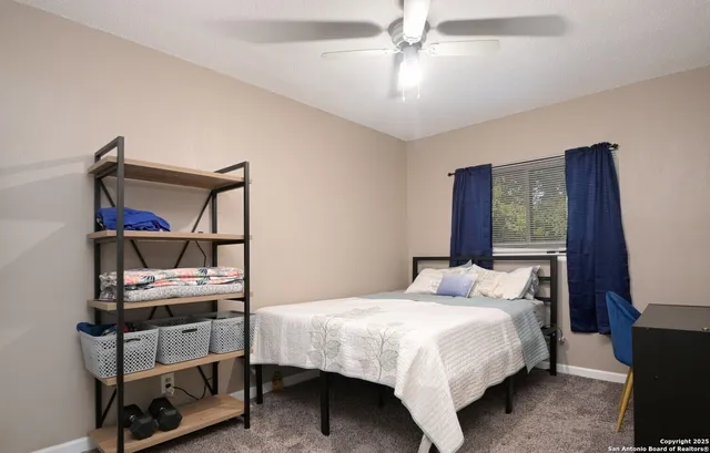 a bedroom with a bed a chandelier and a window