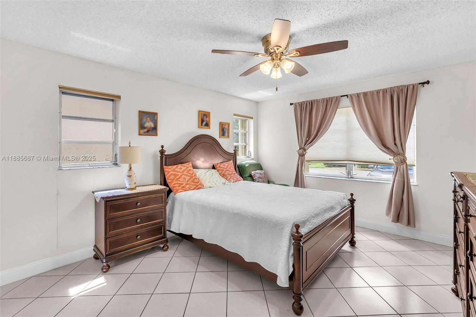 150 South Hollybrook Terrace, Unit 101 Pembroke Pines, FL 33025 - Photo 11 of 31 a bedroom with a bed and a chandelier