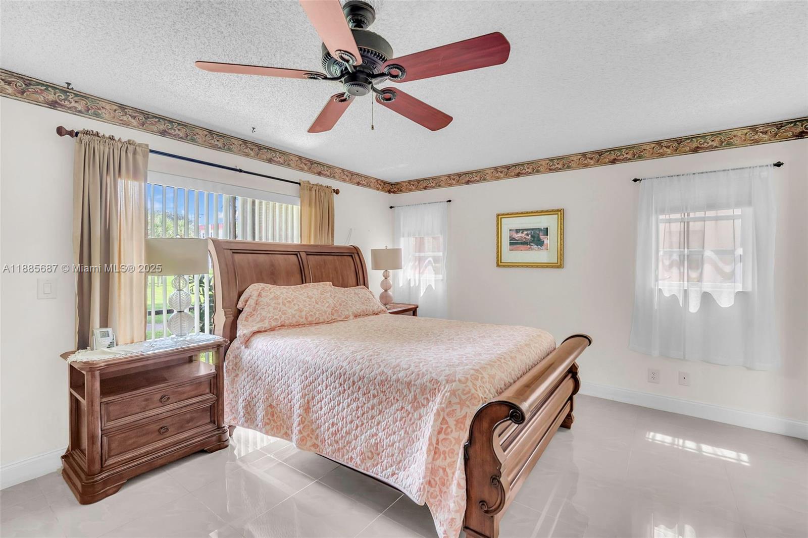 150 South Hollybrook Terrace, Unit 101 Pembroke Pines, FL 33025 - Photo 13 of 31 a bedroom with a bed and a chandelier