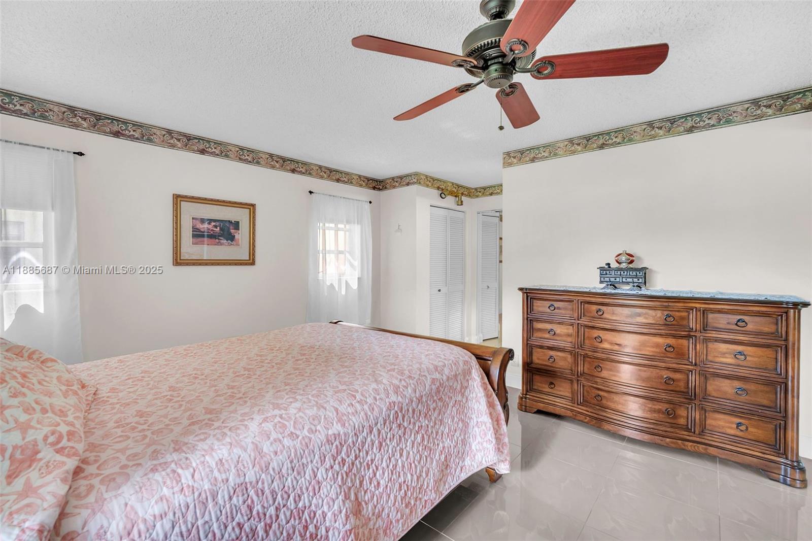 150 South Hollybrook Terrace, Unit 101 Pembroke Pines, FL 33025 - Photo 14 of 31 a bedroom with a bed and a chandelier