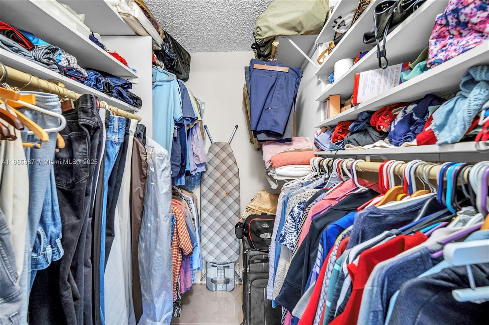 150 South Hollybrook Terrace, Unit 101 Pembroke Pines, FL 33025 - Photo 15 of 31 a view of walk in closet with clothes and shoes