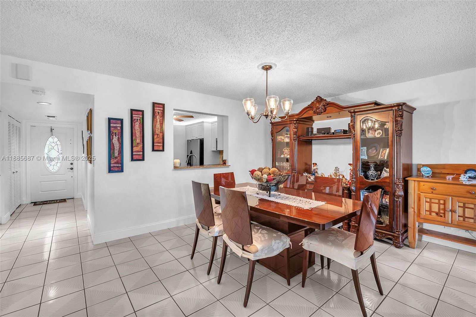 150 South Hollybrook Terrace, Unit 101 Pembroke Pines, FL 33025 - Photo 6 of 31 a view of a dining room with furniture and chandelier