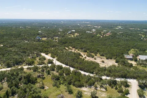 an aerial view of residential houses with city view